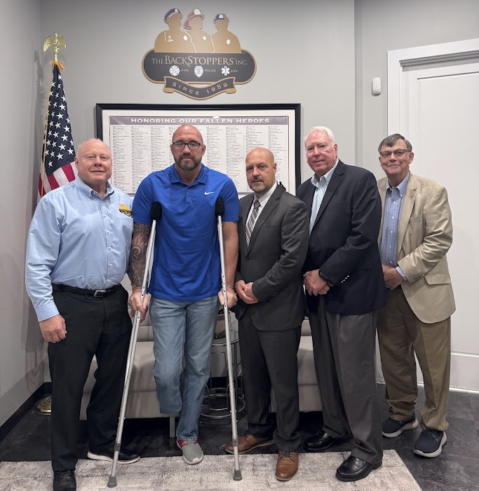 In this Photo: Lt. Col. Lawrence O'Toole, Officer Lee Brousseau, Chief Chris Modrusic, John Sondag, Dan Raniere